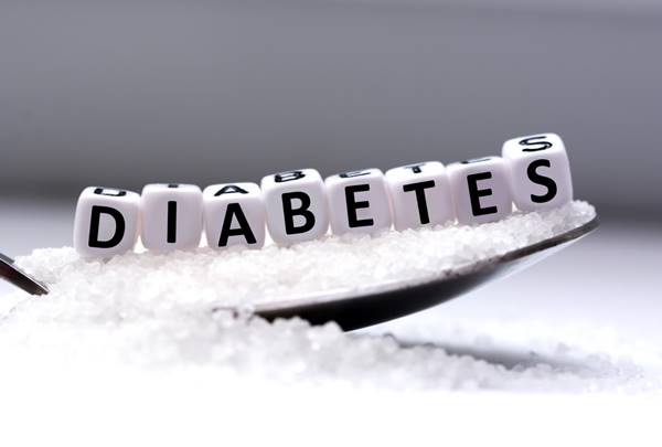 Diabetes letters on a spoon with sugar